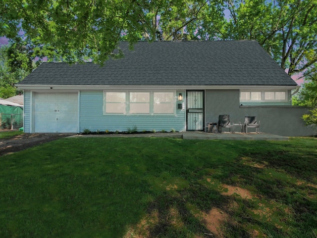 4838 Calvin Dr, Columbus, OH 43227 - view of front of home featuring a front lawn, an attached garage, asphalt driveway, and roof with shingles