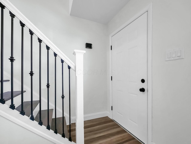 4838 Calvin Dr, Columbus, OH 43227 - foyer entrance with dark wood finished floors, stairway, and baseboards