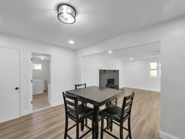4838 Calvin Dr, Columbus, OH 43227 - dining room with light wood finished floors, a fireplace, baseboards, washer / clothes dryer, and recessed lighting