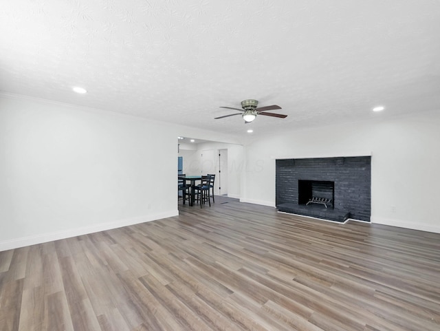4838 Calvin Dr, Columbus, OH 43227 - unfurnished living room featuring ceiling fan, recessed lighting, wood finished floors, baseboards, and a textured ceiling