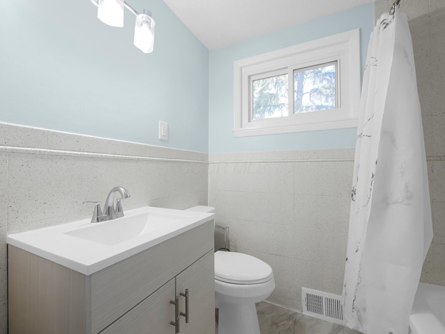 4838 Calvin Dr, Columbus, OH 43227 - full bathroom featuring toilet, vanity, and a wainscoted wall