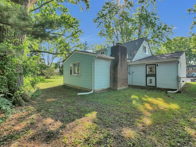 4838 Calvin Dr, Columbus, OH 43227 - rear view of house featuring a chimney and a yard