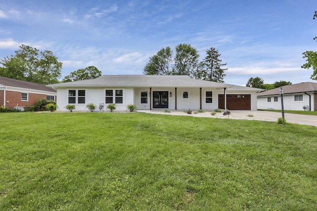 2727 Westmont Blvd, Columbus, OH 43221 - ranch-style house with an attached garage, driveway, a front lawn, and stucco siding