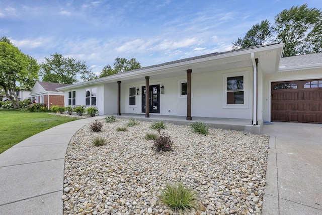 2727 Westmont Blvd, Columbus, OH 43221 - single story home with a porch, an attached garage, stucco siding, a front lawn, and concrete driveway