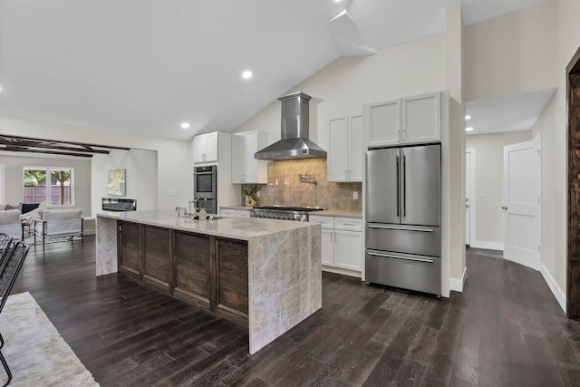 2727 Westmont Blvd, Columbus, OH 43221 - kitchen featuring appliances with stainless steel finishes, wall chimney exhaust hood, backsplash, an island with sink, and dark wood-type flooring