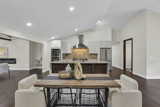 2727 Westmont Blvd, Columbus, OH 43221 - dining space with dark wood-style flooring, baseboards, recessed lighting, and high vaulted ceiling