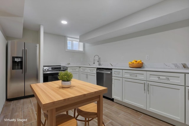 2727 Westmont Blvd, Columbus, OH 43221 - kitchen with stainless steel appliances, wood finish floors, light countertops, a sink, and recessed lighting