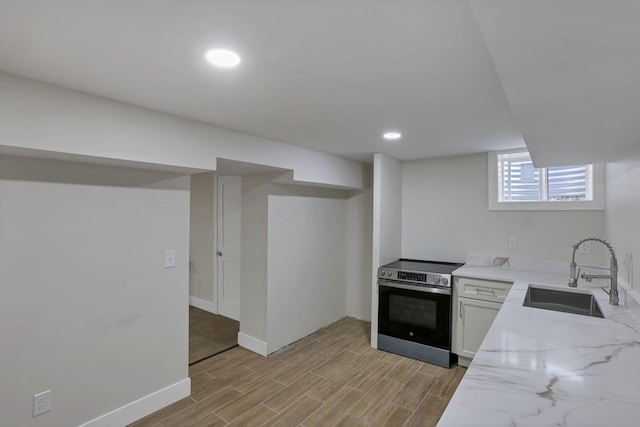 2727 Westmont Blvd, Columbus, OH 43221 - kitchen featuring stainless steel electric range oven, a sink, light stone countertops, light wood-style flooring, and baseboards