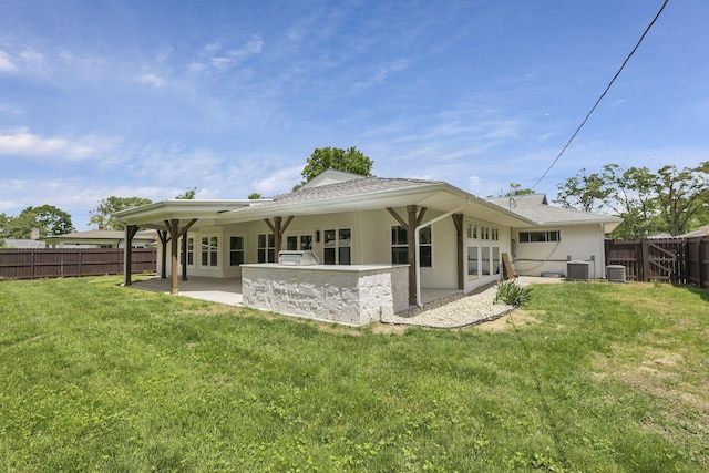 2727 Westmont Blvd, Columbus, OH 43221 - back of property with a patio area, stucco siding, central AC unit, and a shingled roof