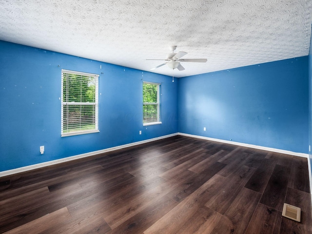 empty room featuring wood finished floors, a ceiling fan, baseboards, and a textured ceiling