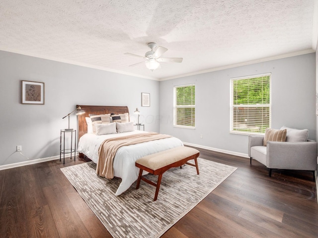 bedroom with ornamental molding, baseboards, dark wood-type flooring, a ceiling fan, and a textured ceiling