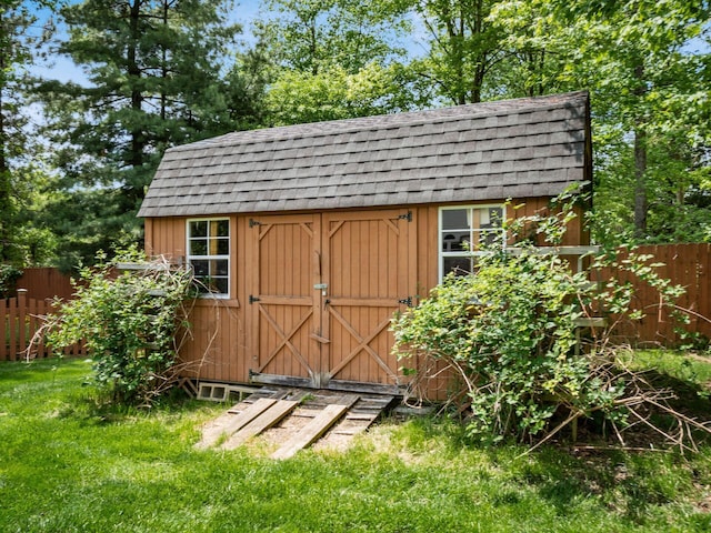 view of shed featuring fence