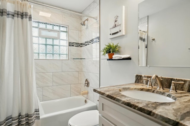 full bath featuring shower / bathtub combination with curtain, vanity, and toilet