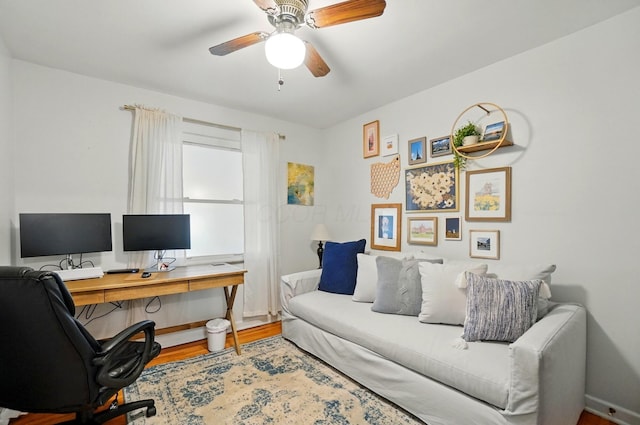 office featuring wood finished floors, ceiling fan, and baseboards