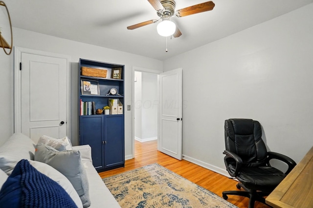 office area featuring light wood-type flooring, baseboards, and a ceiling fan