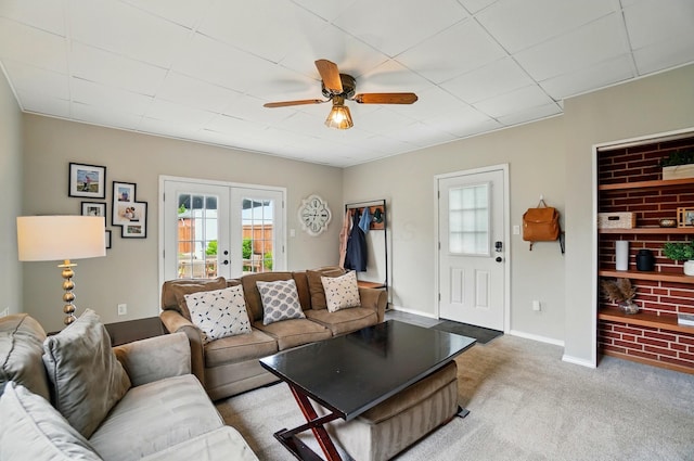 carpeted living room featuring french doors, ceiling fan, and baseboards