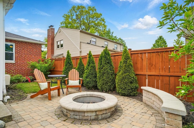 view of patio with a fenced backyard and a fire pit