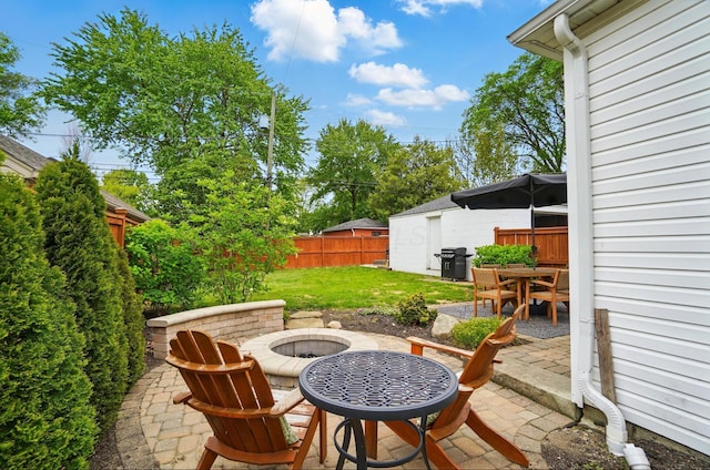 view of patio with a fire pit, outdoor dining space, and area for grilling
