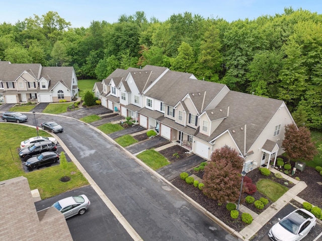 aerial view of residential area featuring a forest