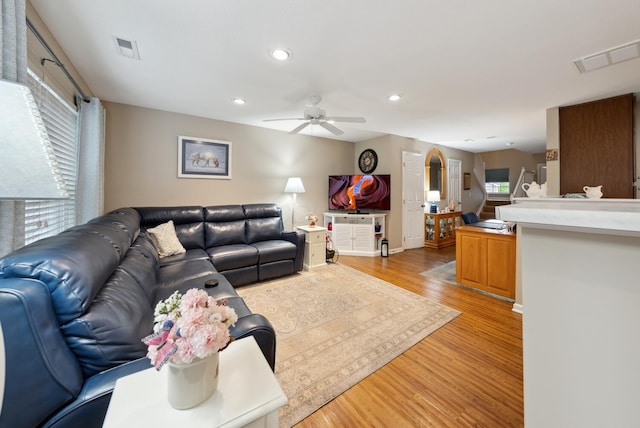 living area featuring a ceiling fan, light wood-type flooring, recessed lighting, and baseboards