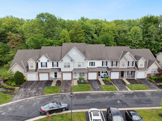 view of subject property featuring a heavily wooded area