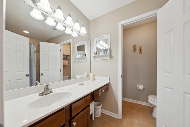 bathroom featuring toilet, tile patterned floors, vanity, baseboards, and a shower with shower curtain