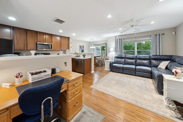office space featuring a ceiling fan, light wood-type flooring, recessed lighting, and a sink