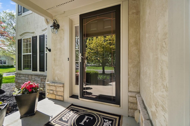 6415 Green Stone Loop, Dublin, OH 43016 - property entrance featuring stone siding, stucco siding, and covered porch