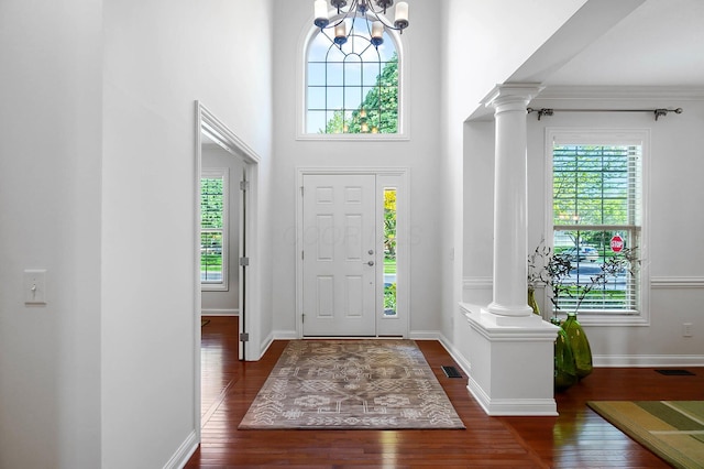 6415 Green Stone Loop, Dublin, OH 43016 - foyer featuring ornate columns, wood finished floors, a chandelier, baseboards, and a towering ceiling