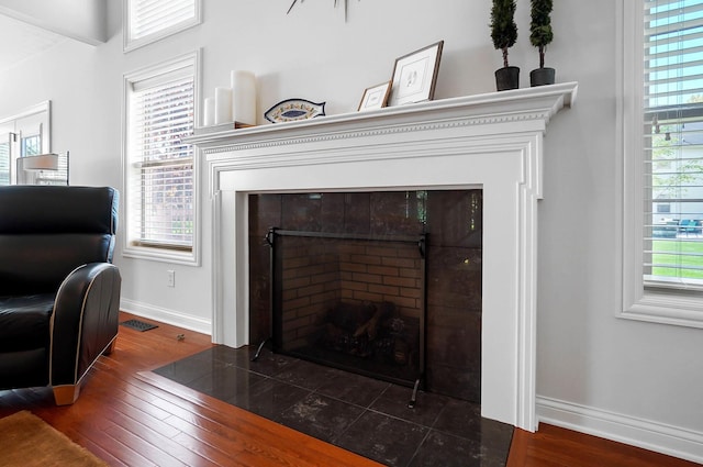 6415 Green Stone Loop, Dublin, OH 43016 - detailed view of a tile fireplace, baseboards, and wood finished floors