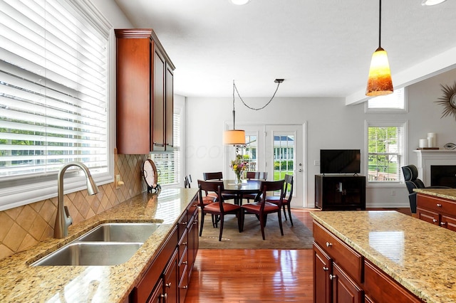 6415 Green Stone Loop, Dublin, OH 43016 - kitchen featuring a sink, dark wood-style flooring, hanging light fixtures, and open floor plan