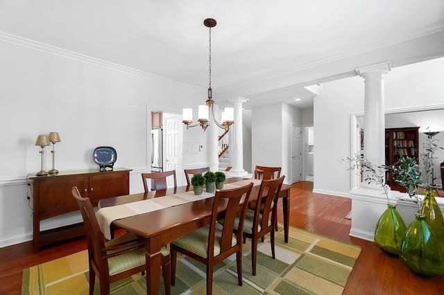 6415 Green Stone Loop, Dublin, OH 43016 - dining room featuring light wood-style floors, ornamental molding, baseboards, decorative columns, and a chandelier