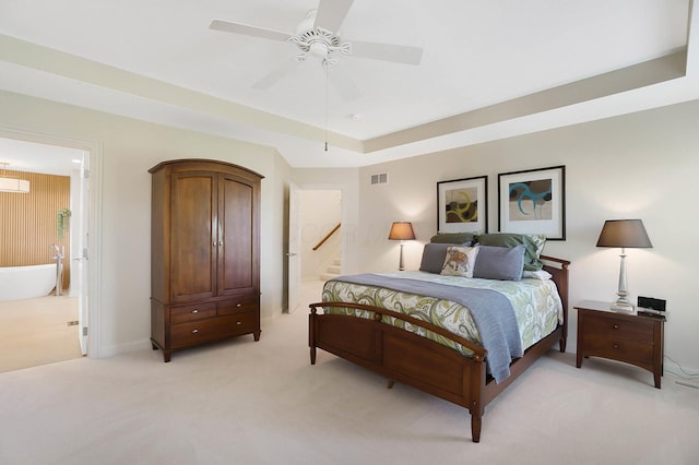 6415 Green Stone Loop, Dublin, OH 43016 - bedroom featuring light colored carpet, connected bathroom, a raised ceiling, a ceiling fan, and baseboards