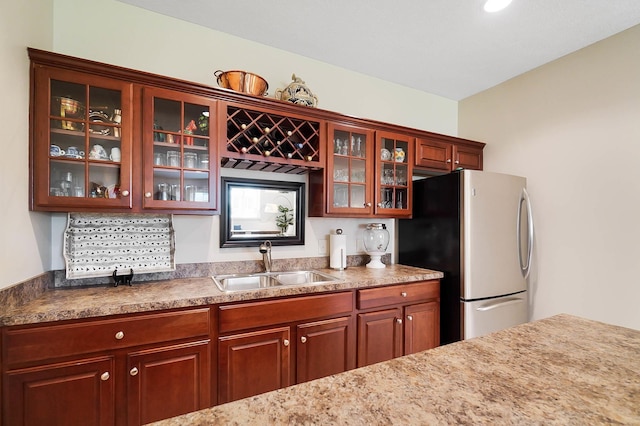 6415 Green Stone Loop, Dublin, OH 43016 - kitchen featuring a sink, freestanding refrigerator, glass insert cabinets, and light countertops