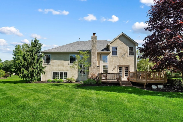 6415 Green Stone Loop, Dublin, OH 43016 - back of property with stucco siding, a deck, a lawn, a chimney, and roof with shingles