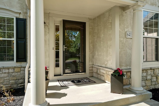 6415 Green Stone Loop, Dublin, OH 43016 - entrance to property featuring stone siding, covered porch, and stucco siding