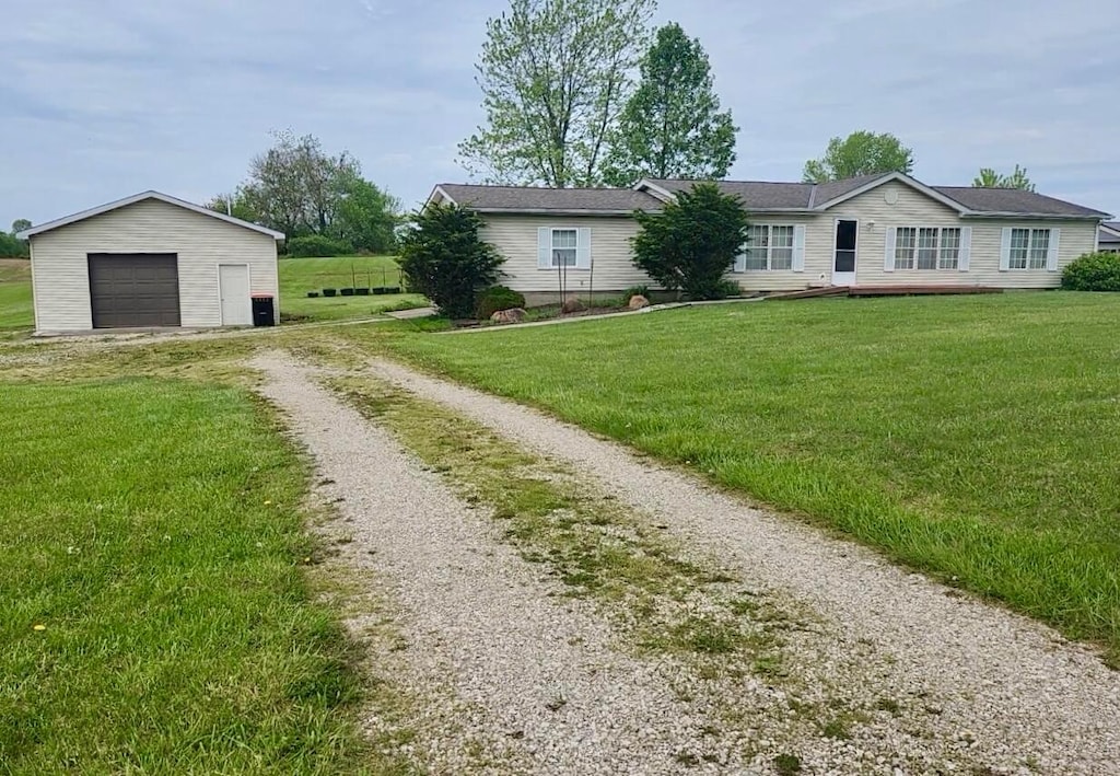 7875 Green Mill Rd, Johnstown, OH 43031 - ranch-style house featuring driveway, a garage, an outbuilding, and a front lawn