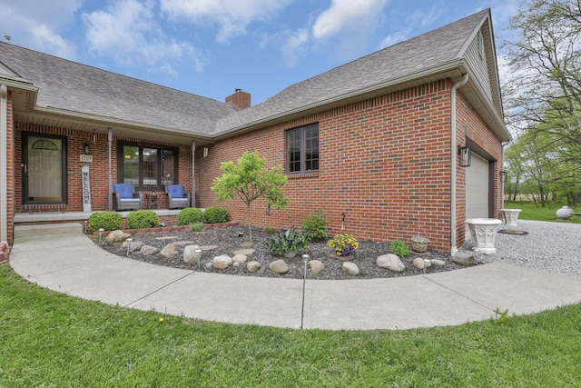 1719 Marion Rd NW, Utica, OH 43080 - view of side of home with brick siding, covered porch, an attached garage, roof with shingles, and a chimney