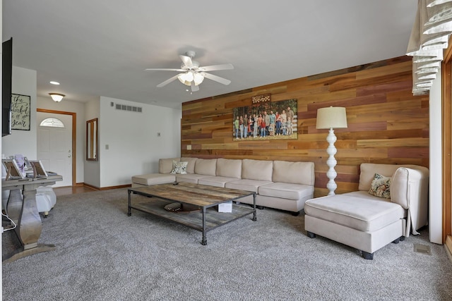1719 Marion Rd NW, Utica, OH 43080 - carpeted living area featuring a ceiling fan, wood walls, and baseboards