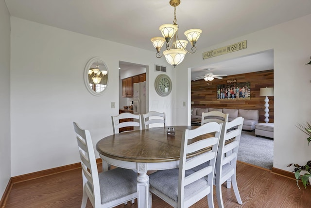 1719 Marion Rd NW, Utica, OH 43080 - dining room with wood finished floors, a ceiling fan, baseboards, and wooden walls