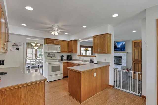 1719 Marion Rd NW, Utica, OH 43080 - kitchen with white appliances, a peninsula, a sink, ceiling fan, and light wood-style floors