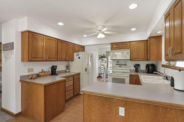 1719 Marion Rd NW, Utica, OH 43080 - kitchen featuring white appliances, ceiling fan, a sink, brown cabinets, and a peninsula