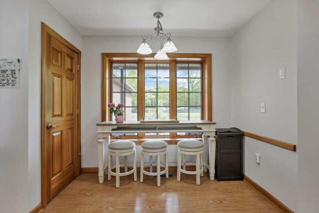 1719 Marion Rd NW, Utica, OH 43080 - dining space featuring a chandelier, light wood-style flooring, and baseboards