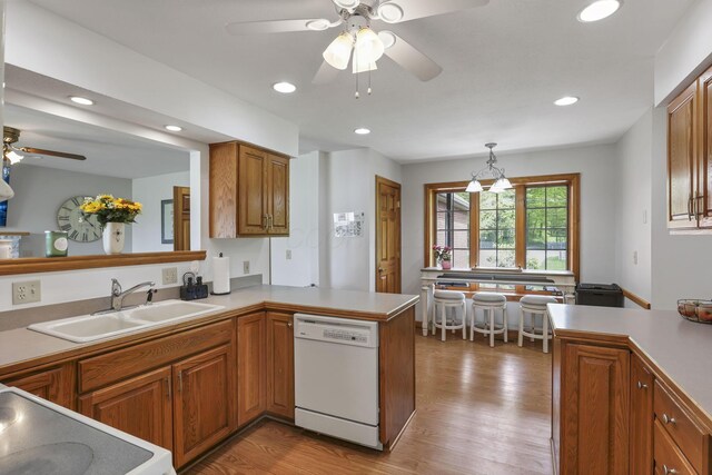 1719 Marion Rd NW, Utica, OH 43080 - kitchen featuring dishwasher, a sink, a ceiling fan, a peninsula, and brown cabinets