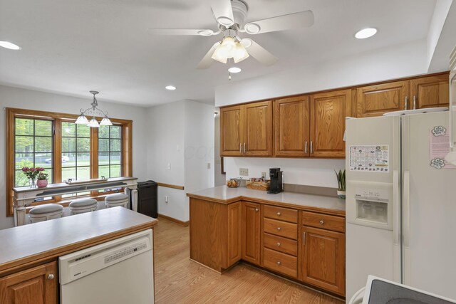 1719 Marion Rd NW, Utica, OH 43080 - kitchen with white appliances, brown cabinetry, light wood-style floors, decorative light fixtures, and recessed lighting