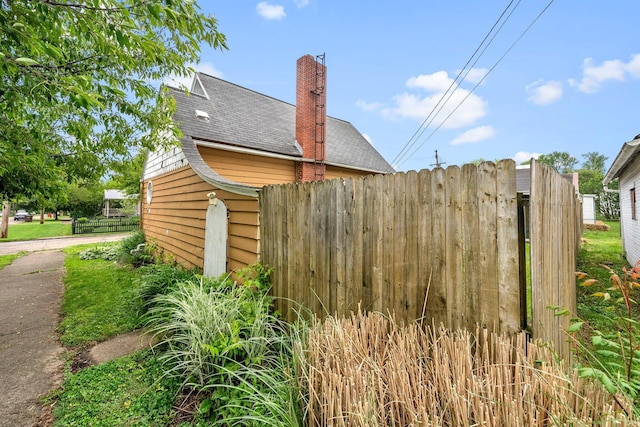 616 E Chestnut St, Mount Vernon, OH 43050 - view of home's exterior featuring a shingled roof and a chimney