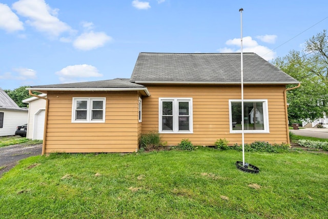 616 E Chestnut St, Mount Vernon, OH 43050 - rear view of house with a lawn, a garage, driveway, and roof with shingles