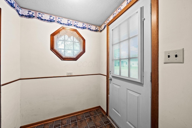 616 E Chestnut St, Mount Vernon, OH 43050 - doorway to outside with a textured ceiling and baseboards