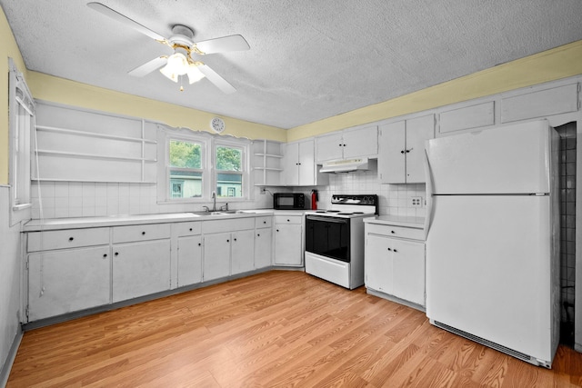 616 E Chestnut St, Mount Vernon, OH 43050 - kitchen with freestanding refrigerator, range with electric cooktop, open shelves, under cabinet range hood, and black microwave