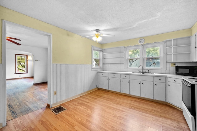 616 E Chestnut St, Mount Vernon, OH 43050 - kitchen with open shelves, black microwave, a sink, ceiling fan, and white electric range